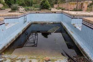 A dirty swimming pool requiring complete draining